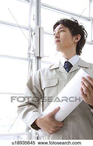 Architect holding a blueprint View Large Photo Image Stock Photography - Architect holding a blueprint. Fotosearch