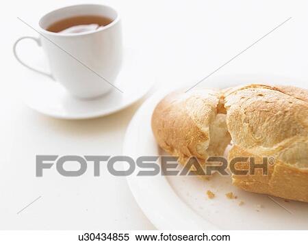 Stock Photography - Baguette and cup of tea. Fotosearch