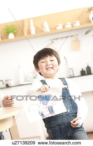 Boy holding drawing View Large Photo Image Stock Photo - Boy holding drawing. Fotosearch