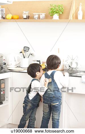 Brothers in a kitchen View Large Photo Image Stock Photo - Brothers in a kitchen. Fotosearch