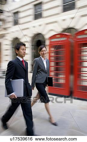 Stock Photograph - Businessman and Businesswoman Walking in London. Fotosearch