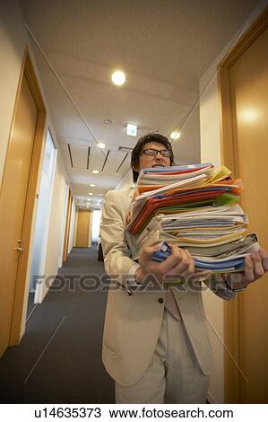 Businessman carrying files View Large Photo Image Stock Image - Businessman carrying files. Fotosearch