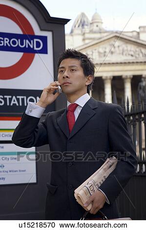 Stock Image - Businessman on Phone Outside Underground Station. Fotosearch