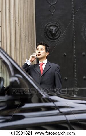 Businessman On The Phone Near Black Cab View Large Photo Image Stock Image - Businessman On The Phone Near Black Cab. Fotosearch