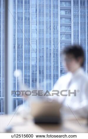 Stock Image - Businessman reading newspaper. Fotosearch