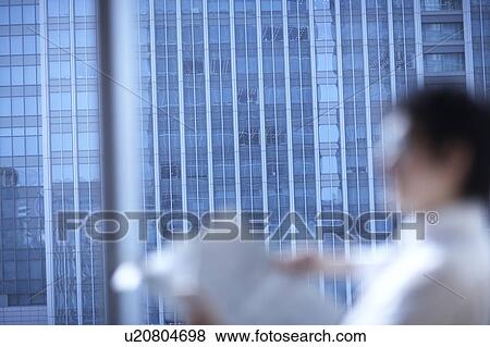 Stock Photo - Businessman reading newspaper. Fotosearch