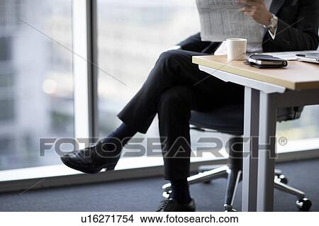 Picture - Businessman sitting on chair, low section. Fotosearch