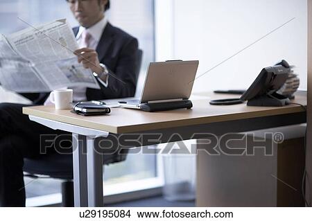 Picture - Businessman sitting on chair, midsection. Fotosearch