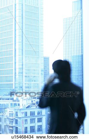 Picture - Businessman using a mobile phone, Tokyo Prefecture, Honshu, Japan. Fotosearch