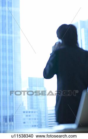 Stock Image - Businessman using a mobile phone, Tokyo Prefecture, Honshu, Japan. Fotosearch