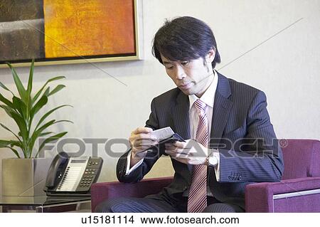 Picture - Businessman waiting at reception area. Fotosearch