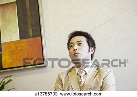 Stock Image - Businessman waiting at reception area. Fotosearch
