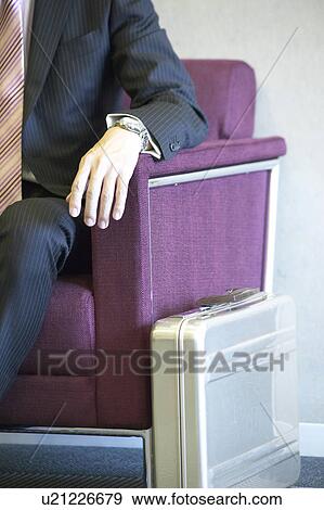 Businessman waiting at reception area View Large Photo Image Stock Photo - Businessman waiting at reception area. Fotosearch