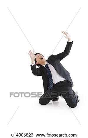 Stock Image - Businessman with arms raised. Fotosearch