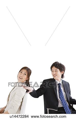 Businessman with hand on businesswoman's shoulder View Large Photo Image Picture - Businessman with hand on businesswoman's shoulder. Fotosearch