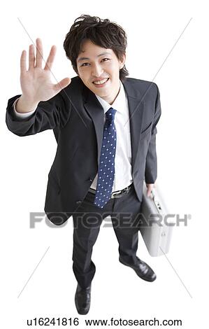 Businessman with hand raised View Large Photo Image Stock Photograph - Businessman with hand raised. Fotosearch