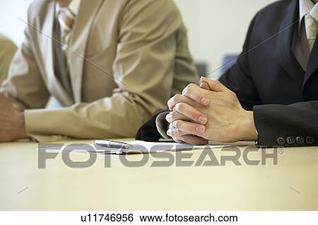Stock Photograph - Businessman with hands clasped. Fotosearch