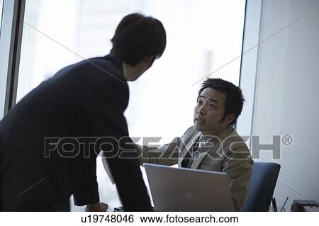 Stock Photograph - Businessmen talking. Fotosearch