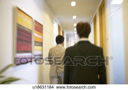 Picture - Businessmen walking in the office. Fotosearch
