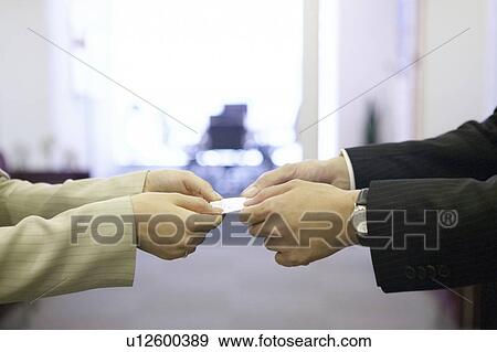 Businesspeople exchanging business card View Large Photo Image Stock Photo - Businesspeople exchanging business card. Fotosearch