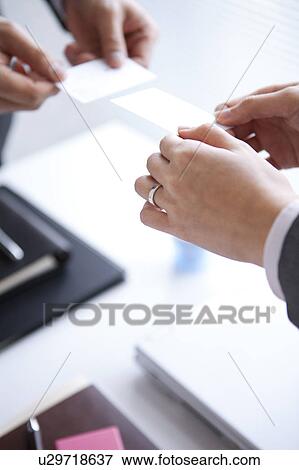 Stock Photo - Businesspeople exchanging business cards. Fotosearch