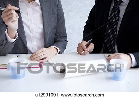 Businesspeople having a meeting View Large Photo Image Stock Image - Businesspeople having a meeting. Fotosearch