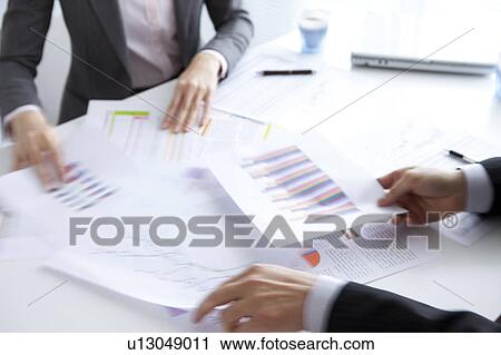 Stock Image - Businesspeople having a meeting. Fotosearch