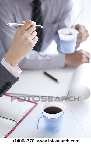 Stock Image - Businesspeople having a meeting. Fotosearch