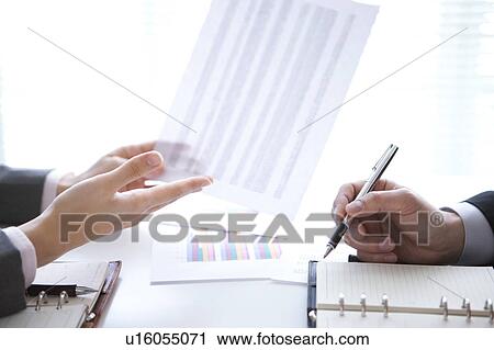 Stock Image - Businesspeople having a meeting. Fotosearch