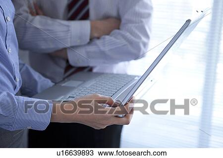 Stock Image - Businesspeople having a meeting. Fotosearch