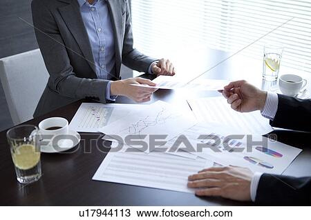 Stock Image - Businesspeople having a meeting. Fotosearch