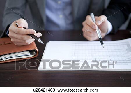Stock Image - Businesspeople having a meeting. Fotosearch