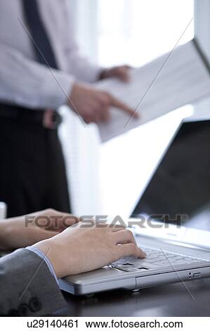 Stock Image - Businesspeople having a meeting. Fotosearch