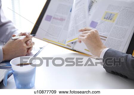 Stock Photo - Businesspeople having a meeting. Fotosearch