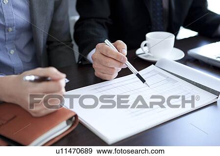 Businesspeople having a meeting View Large Photo Image Stock Photo - Businesspeople having a meeting. Fotosearch