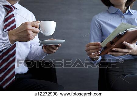 Stock Photo - Businesspeople having a meeting. Fotosearch