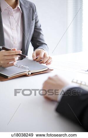 Stock Photo - Businesspeople having a meeting. Fotosearch