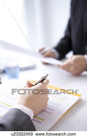 Stock Photo - Businesspeople having a meeting. Fotosearch
