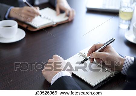 Stock Photograph - Businesspeople having a meeting. Fotosearch