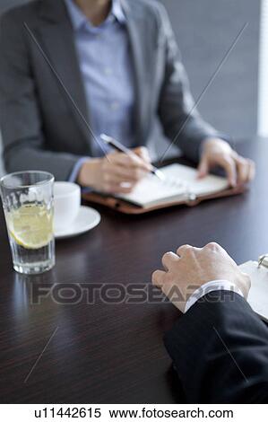 Stock Photography - Businesspeople having a meeting. Fotosearch