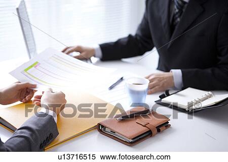 Stock Photography - Businesspeople having a meeting. Fotosearch