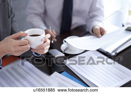 Stock Photography - Businesspeople having a meeting. Fotosearch