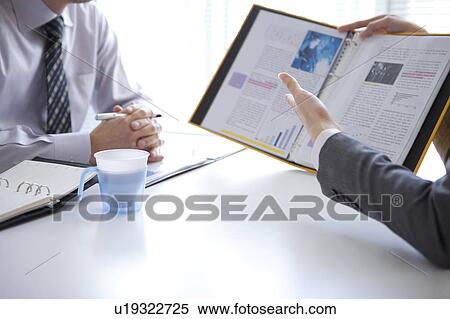 Businesspeople having a meeting View Large Photo Image Stock Photography - Businesspeople having a meeting. Fotosearch