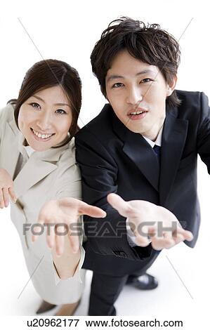 Stock Photo - Businesspeople looking up and reaching out. Fotosearch
