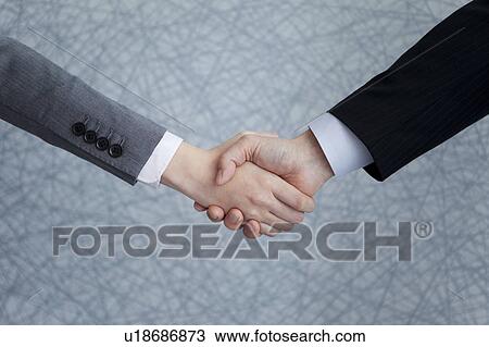 Stock Image - Businesspeople shaking hands. Fotosearch