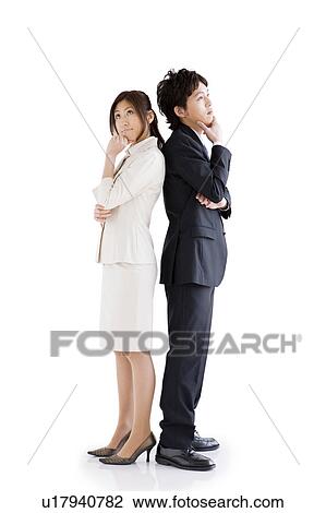 Stock Image - Businesspeople standing back to back. Fotosearch