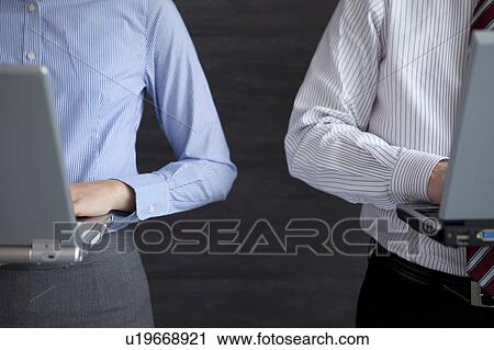 Stock Image - Businesspeople using laptop. Fotosearch