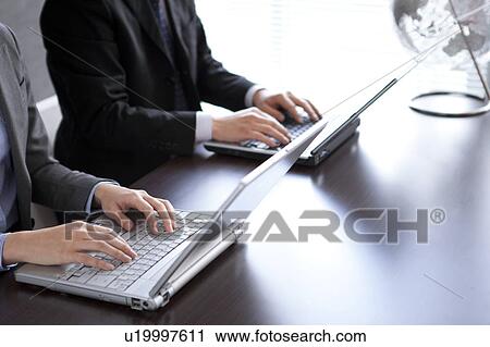 Businesspeople using laptop View Large Photo Image Stock Image - Businesspeople using laptop. Fotosearch
