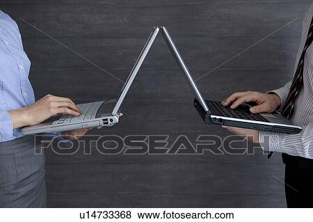 Stock Photo - Businesspeople using laptop. Fotosearch