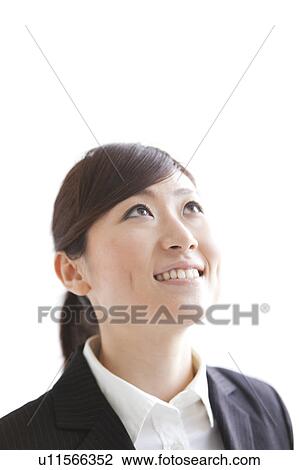 Businesswoman looking up and smiling View Large Photo Image Stock Image - Businesswoman looking up and smiling. Fotosearch